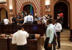 Security forces remove opposition lawmakers gathered at the parliament speaker's table while lawmaker protest.