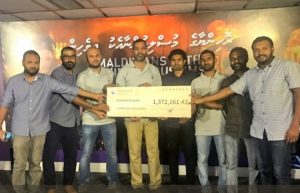 Staff of MPL pose with a cheque of MVR 1.3 million donated to the Maldivians With Rohingya fund. PHOTO/MPL