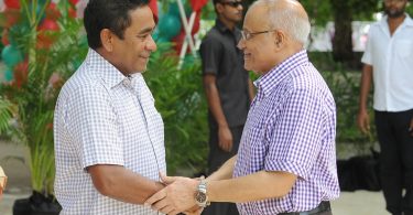 Former president Gayoom (R) shakes the hand of his half brother and incumbent president Yameen at a ceremony. FILE PHOTO/PRESIDENT'S OFFICE