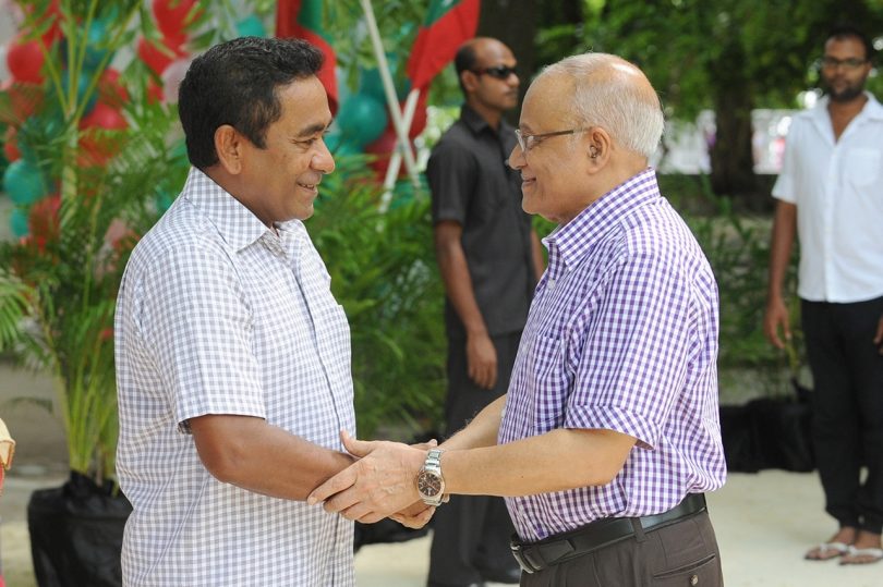 Former president Gayoom (R) shakes the hand of his half brother and incumbent president Yameen at a ceremony. FILE PHOTO/PRESIDENT'S OFFICE