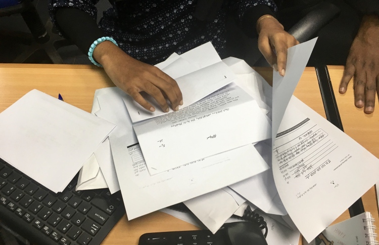 A housing ministry worker handles complaints submitted by the public regarding flat distribution of the government's first social housing project. PHOTO: NISHAN ALI/MIHAARU