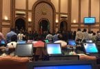 Security officers surround Speaker Maseeh inside the parliament chambers while opposition lawmakers protest.