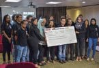 Staff of Raajje TV pose with a check of over MVR 5 million raised by the station to relieve the plight of the Rohingya. PHOTO: HUSSAIN WAHEED/MIHAARU