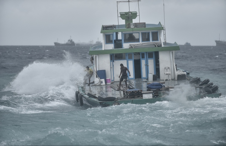 A local boat travels out of the Male harbour in rough seas. PHOTO: NISHAN ALI/MIHAARU