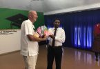 Soneva Jani's general manager Andrew Whiffen presents donations to Noonu Atoll School, received by its principal Abdulla Eesa.