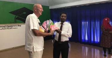 Soneva Jani's general manager Andrew Whiffen presents donations to Noonu Atoll School, received by its principal Abdulla Eesa.