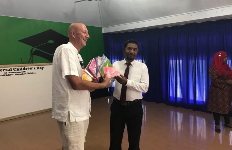 Soneva Jani's general manager Andrew Whiffen presents donations to Noonu Atoll School, received by its principal Abdulla Eesa.