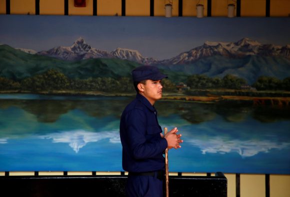 A police officer stands guard as officials start counting votes in Kathmandu's city hall a day after parliamentary and provincial elections in Nepal. December 8, 2017. Photo: Reuters / Navesh Chitrakar 