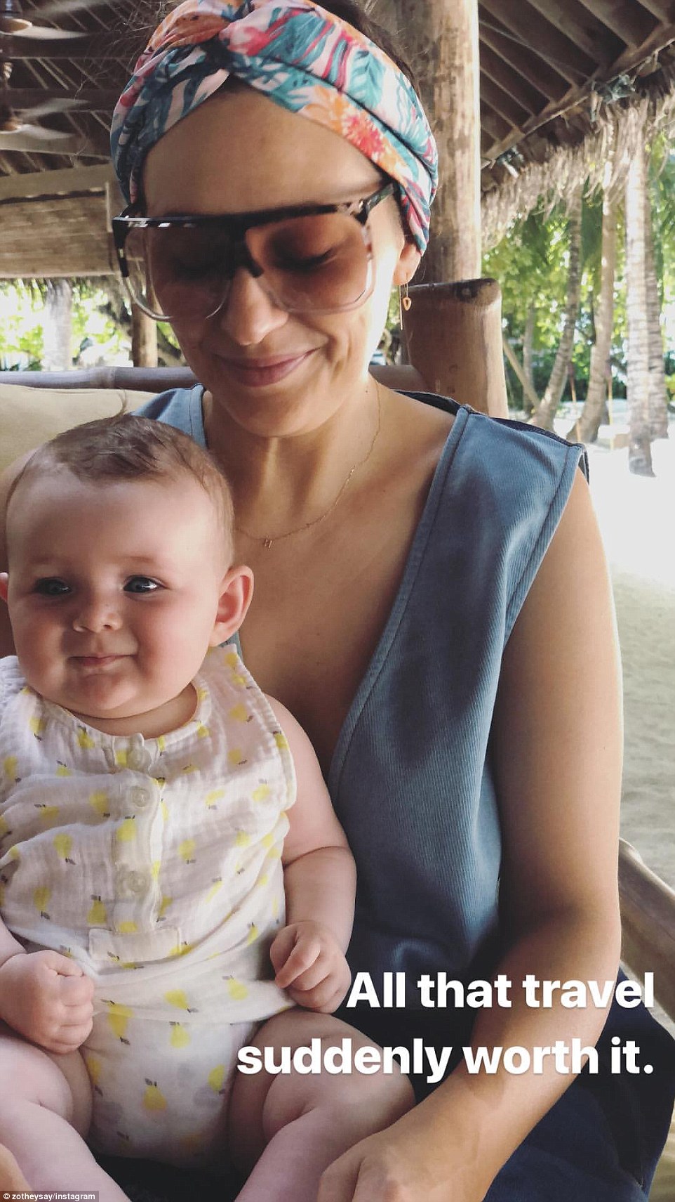 Motherhood goals: The doting mum-of-two shared a second photo to her Insta story that showed her cuddling up to baby Rudy. The cherubic tot looked cute as a button, and perfectly happy in the tropical surroundings as she sat proudly on mum's lap