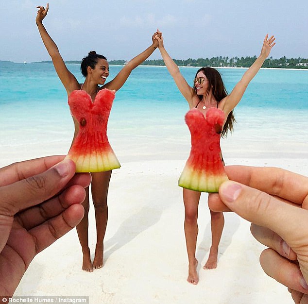 Feeling fruity: Another tropical snap saw the star join an ecstatic pal on the white sand beach while the photographer held up dress shaped watermelon pieces in front of them