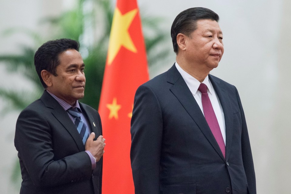 (FILES) In this file photo taken on December 7, 2017 Maldives' President Abdulla Yameen (L) and China's President Xi Jinping listen to their national anthems during a welcome ceremony at the Great Hall of the People in Beijing.Back when he was a mild-mannered civil servant, few in the Maldives predicted Abdulla Yameen would one day run the country, let alone with an iron grip, locking up judges, his rivals and even his 80-year-old half-brother. / AFP PHOTO / Fred DUFOUR