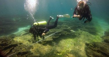 Researchers inspecting coral reefs in the Maldives