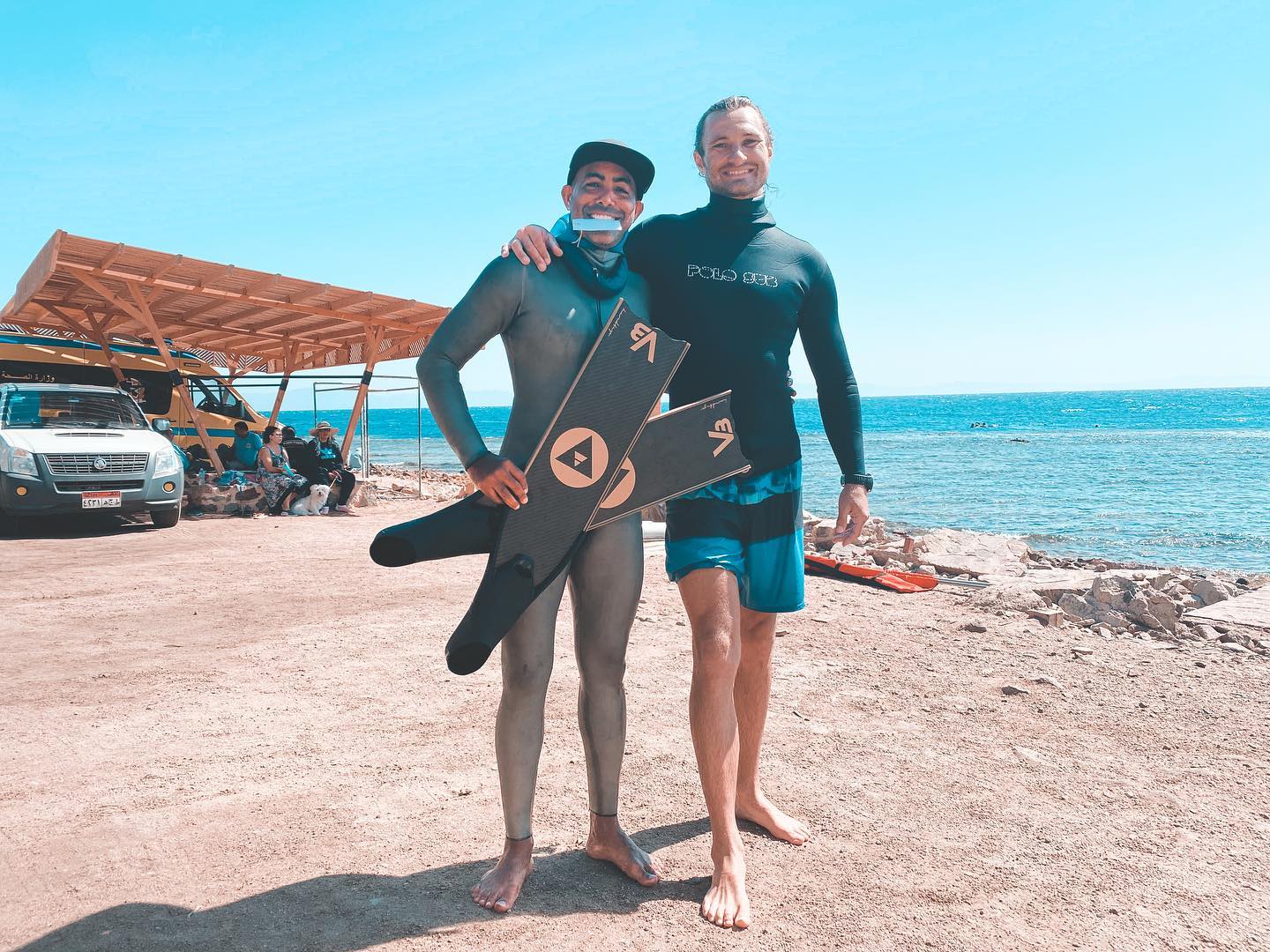 Image may contain: 2 people, ocean, sky, shoes, cloud, outdoor, water and nature