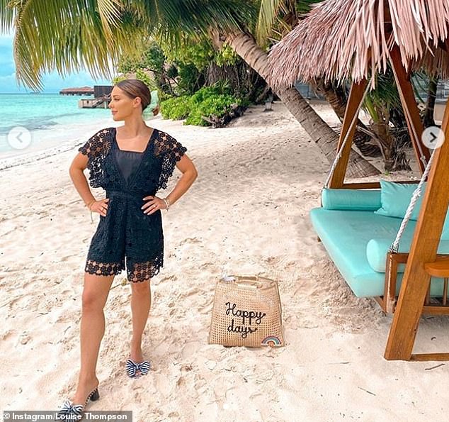 Beach: While many celebrities opted to share images of the poppy - the symbol of the annual Remembrance campaign - in her photo Louise posed in a black playsuit on the beach, with a straw bag emblazoned with 'Happy days' placed behind her'